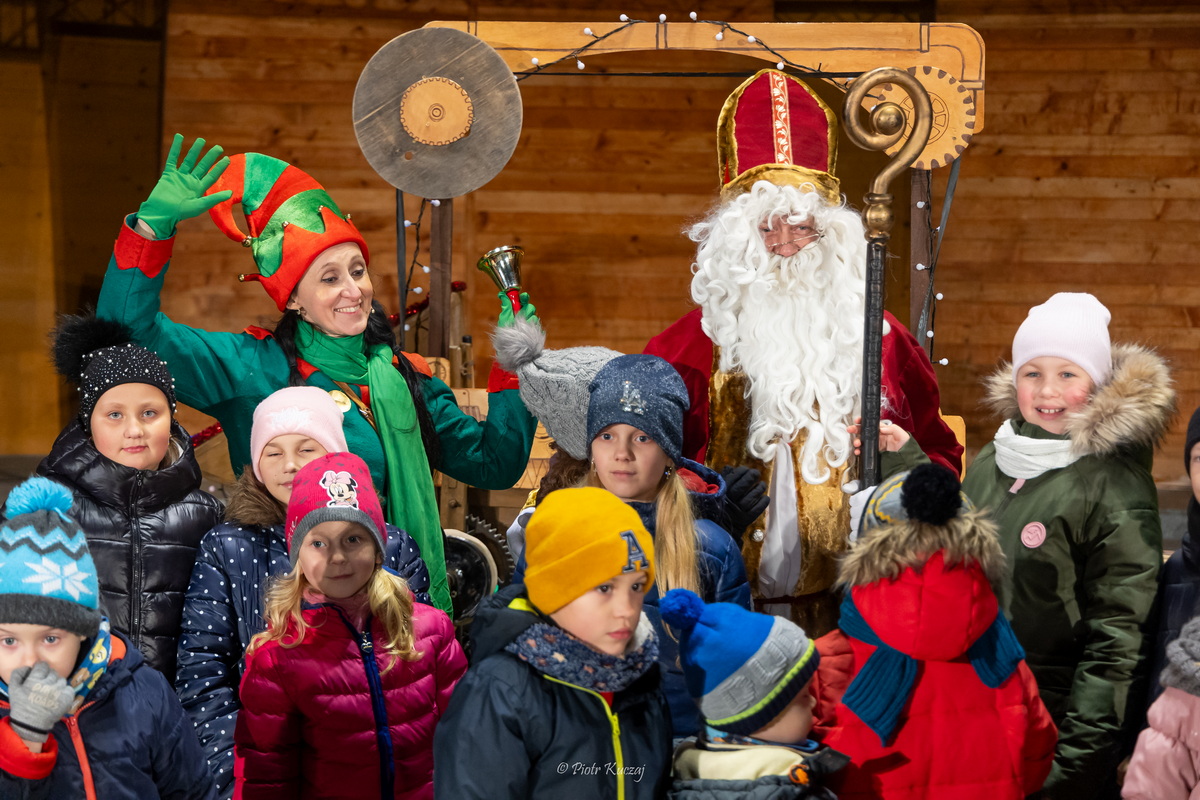 Święty Mikołaj i elf wśród dzieci.